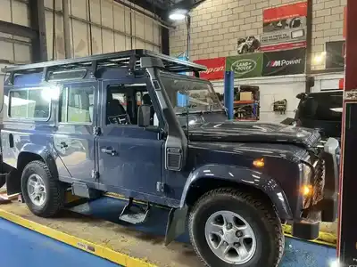 Land Rover vehicles in city and rural settings serviced by AJ 4X4 