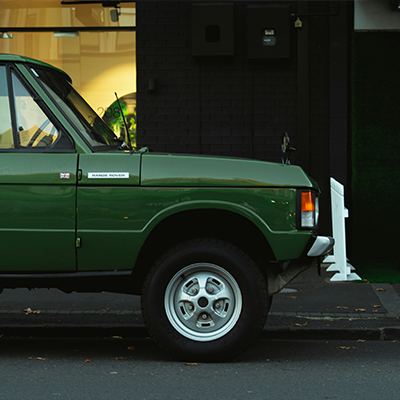 Classic Land Rover parked on a city street serviced by AJ 4X4 